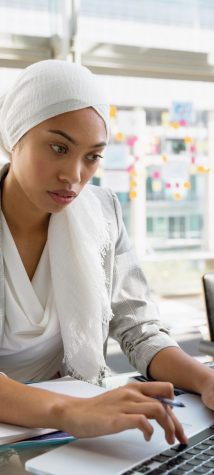 businesswoman-in-hijab-working-on-laptop-at-desk-i-2022-02-08-22-39-26-utc (1)-min